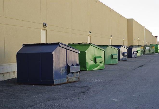 a row of heavy-duty dumpsters ready for use at a construction project in Byron, MI